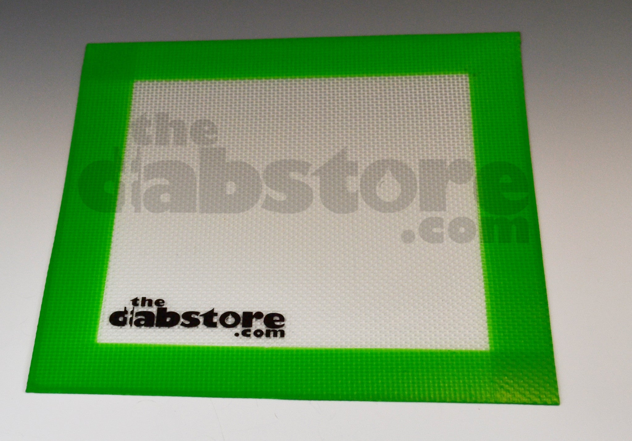 https://www.thedabstore.com/cdn/shop/products/Silicone_Dab_Mat_for_sale_8_in_by_8_in.jpg?v=1481917190